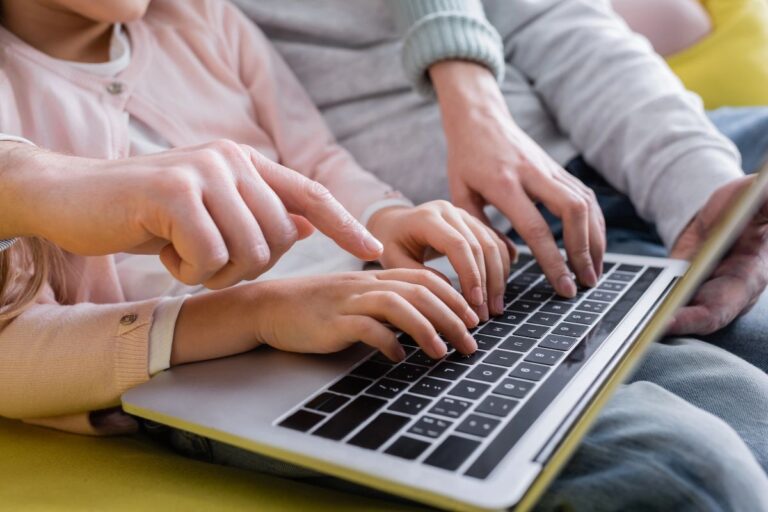 Family using a laptop together to organise emails and household admin.