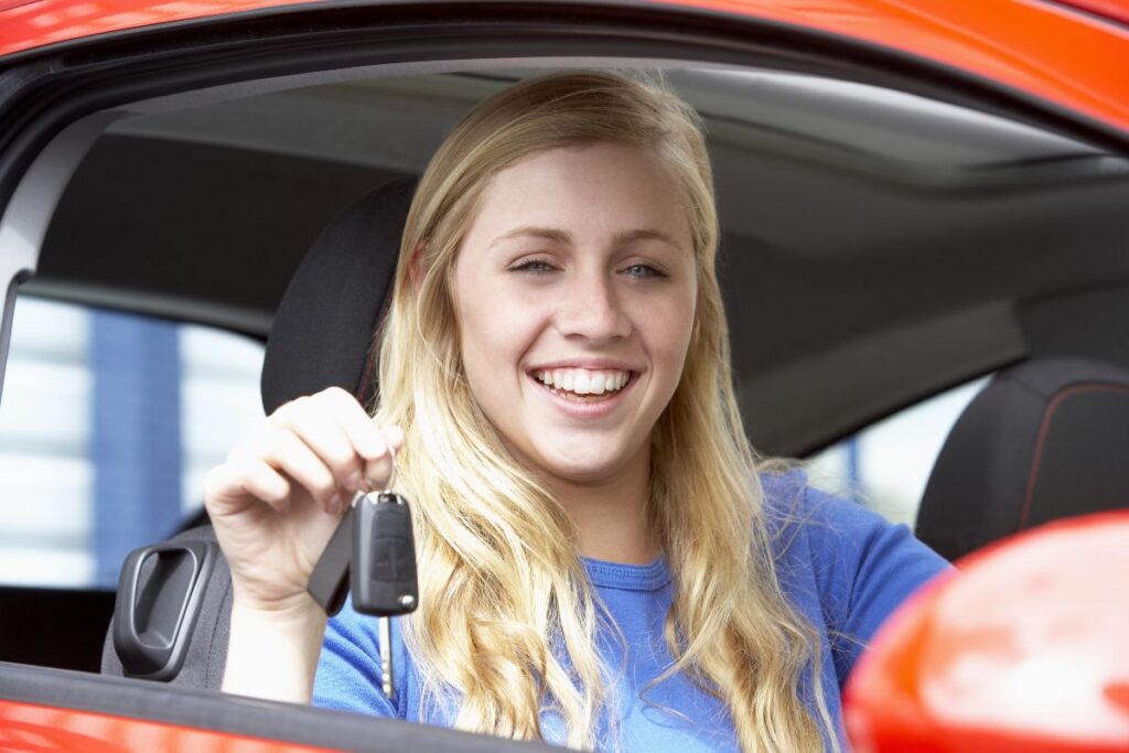 Young adult with the keys to her first car